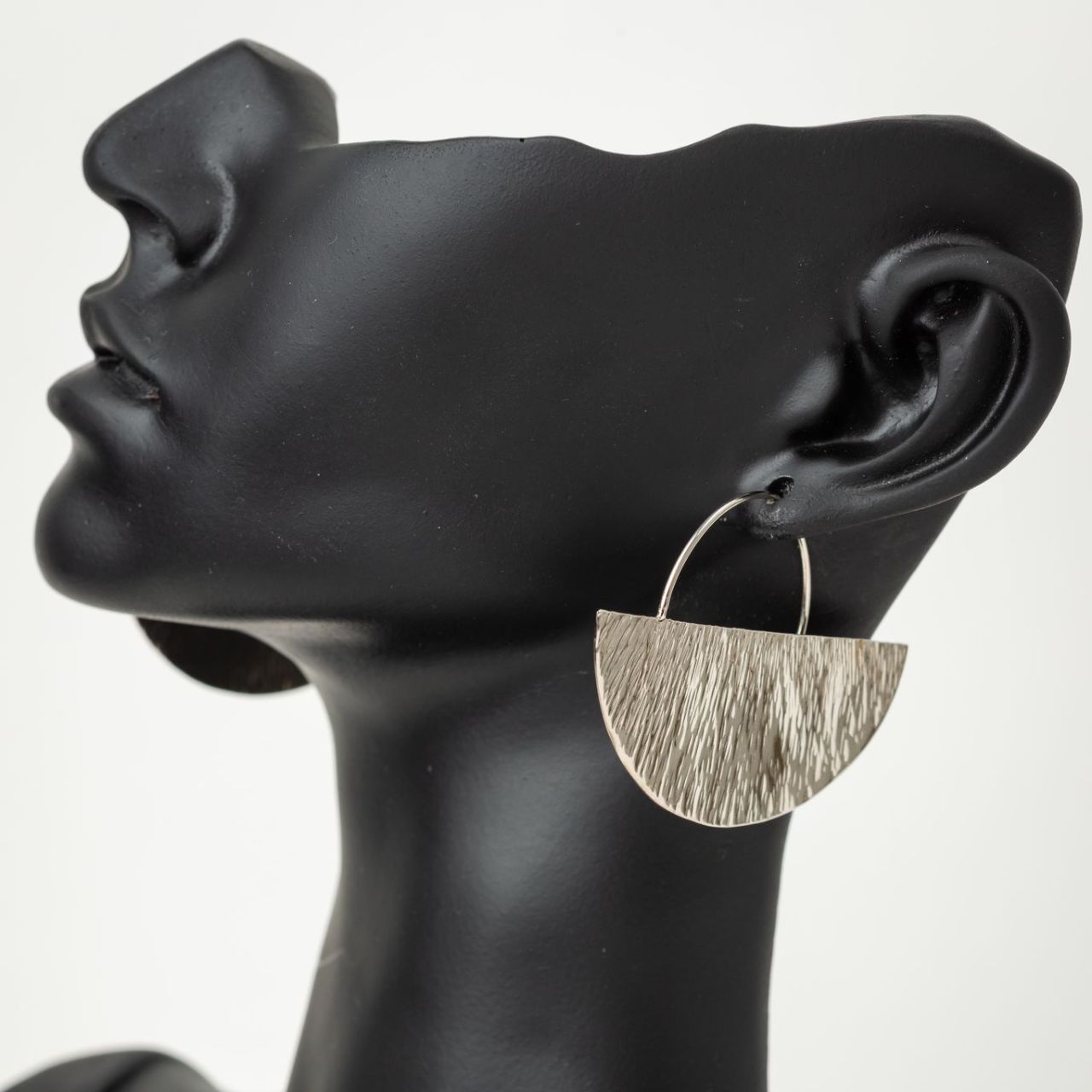 Handmade and hand-hammered silver earrings crafted in Kenya basket