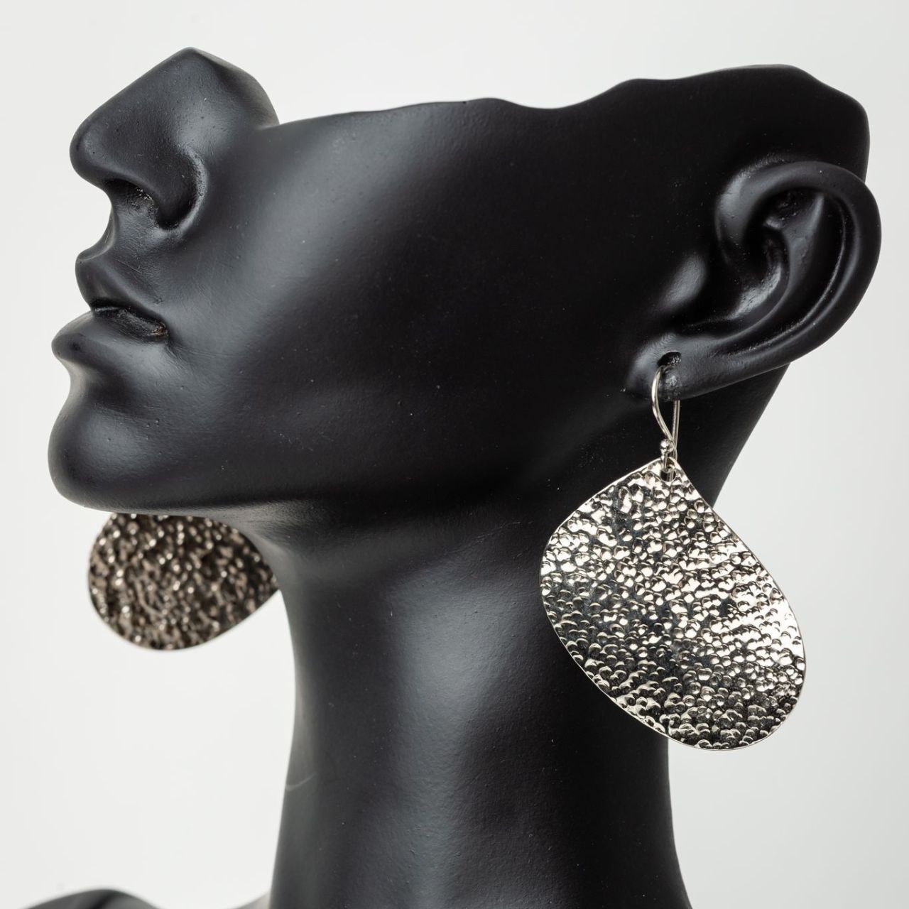 Handmade and hand-hammered silver earrings crafted in Kenya curved