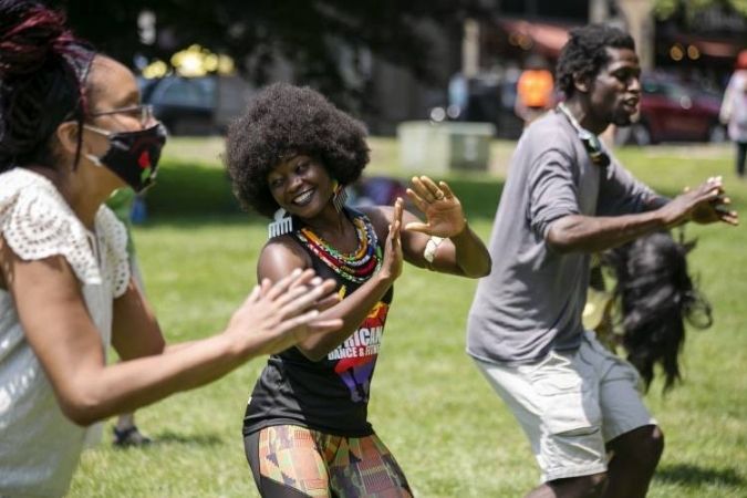Aimee Salmon dancing with others at an event.
