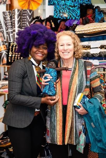 Aimee with a customer holding a handmade cloth Aimee doll