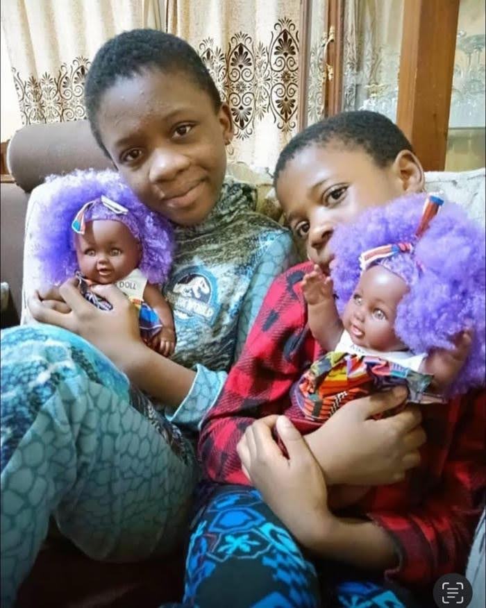 Two children holding purple hair Aimee Dolls